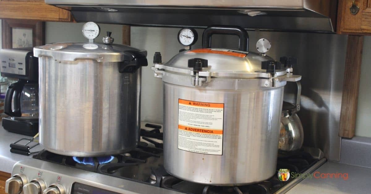 Presto and All American pressure canners sitting on the stove.