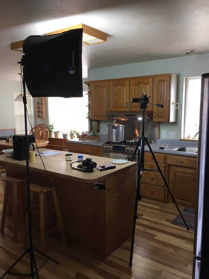 Sharon's kitchen setup with lights and camera on a tripod.