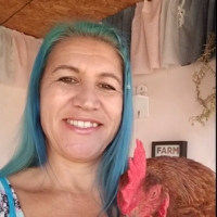 Kristi Stone holding a chicken.