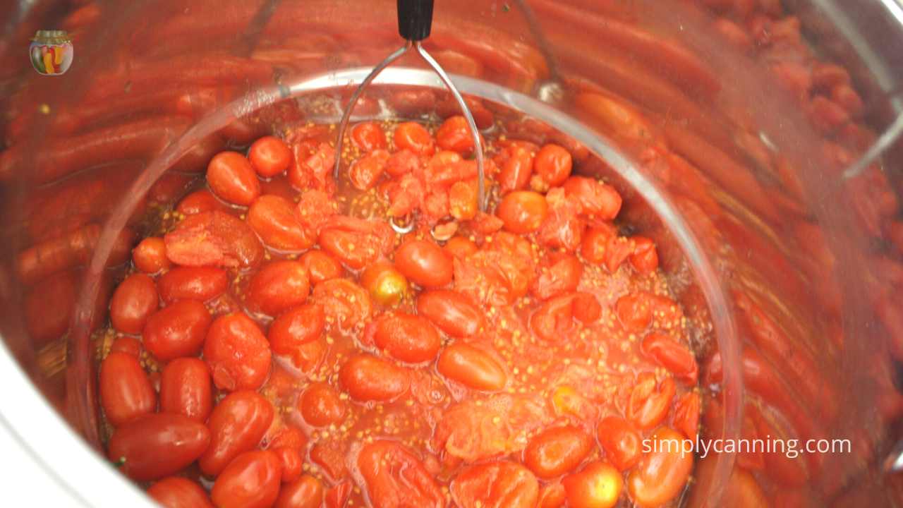 Close up of tomatoes being simmered in a stock pot. 