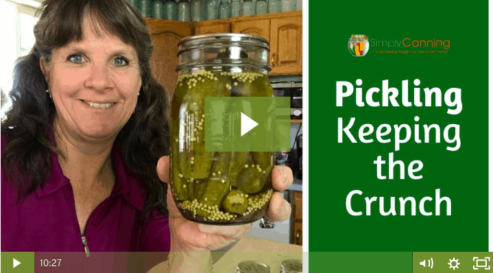 Sharon holding a jar of crunchy dill pickles linking to the member lesson.