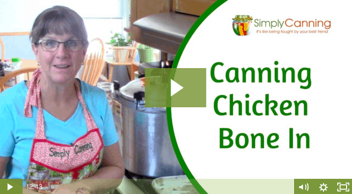 Sharon standing next to a canner in the kitchen linking to the member lesson on canning chicken with the bone in.