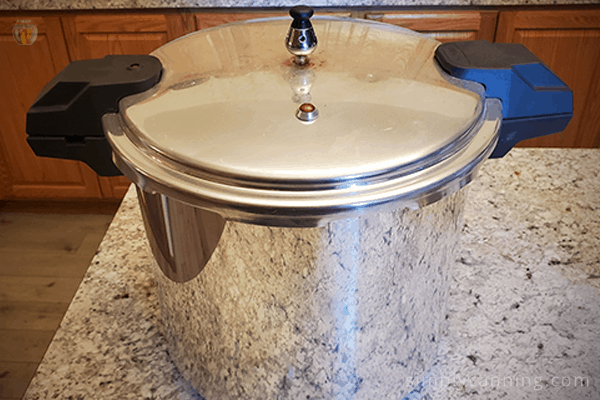 Small Mirro pressure canner with the lid sitting on the kitchen countertop.