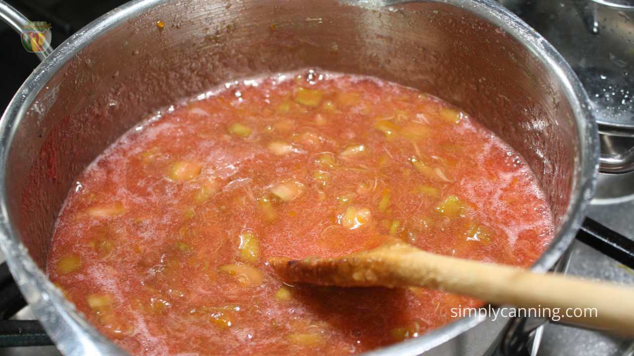 pot of orange rhubarb jam with a cinnamon hue. 