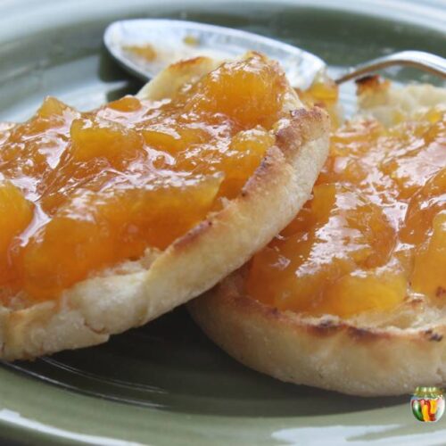 Peach jam spread over toasted English muffins.