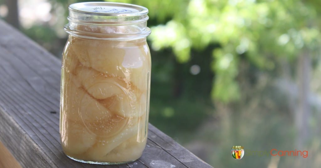 Jar of home canned pears sitting outside.