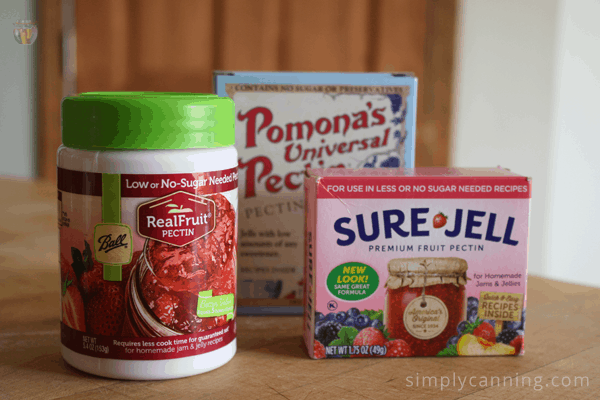 Packages of pectin and Sure Jell sitting on the countertop.