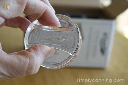 Holding the Mason Tops fermenting weight using its little handle design.