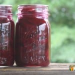 Two Kerr canning jars filled with deep red pickled beets.