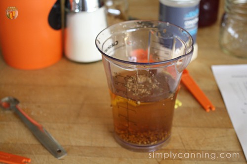 Measuring out brine ingredients in a measuring cup.