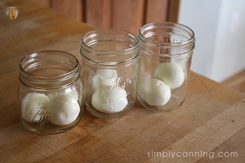 Hardboiled eggs placed in clean glass jars.