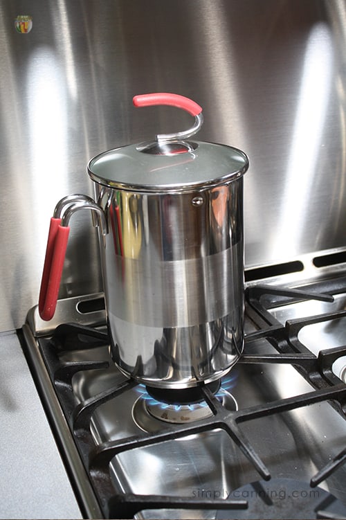 Heating up the fourth burner pot on the stove.