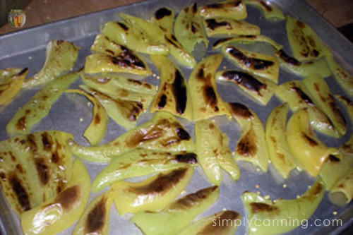 Browned peppers sitting on a cookie sheet.