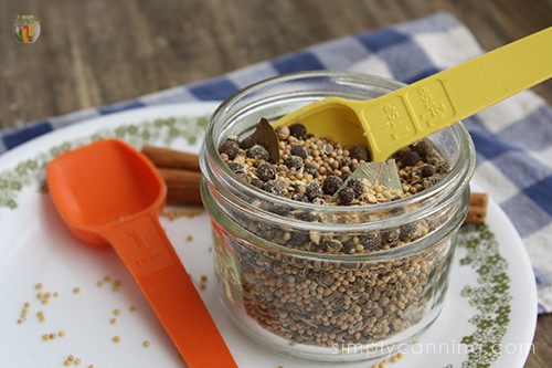 A small canning jar filled with mixed pickled spices.