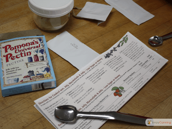A package of Pomona's Pectin with the instruction pamphlet spread over the countertop.