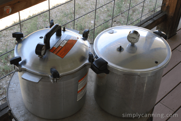 Bulky All American canner sitting next to the sleeker Presto pressure canner.