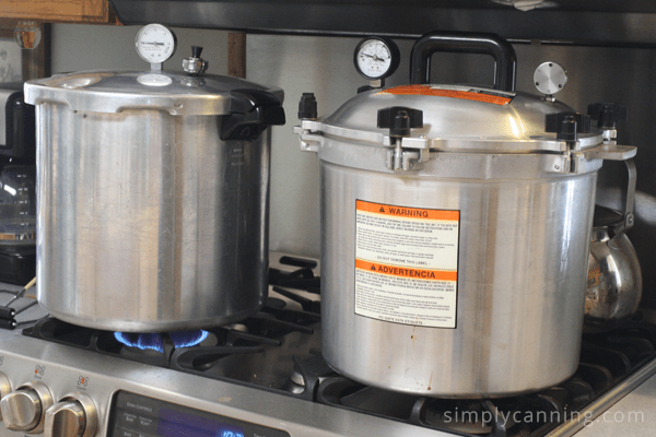 Presto pressure canner sitting next to the All American pressure canner on the range.