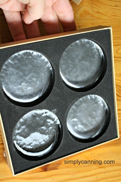 Pickle Pebble glass weights in their box.