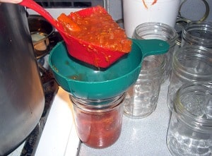 Filling jars with the ladle.