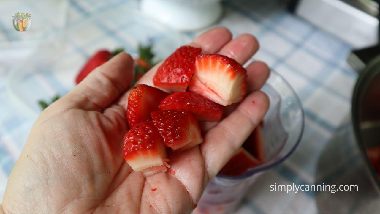 Handful of cleaned quartered strawberries. 