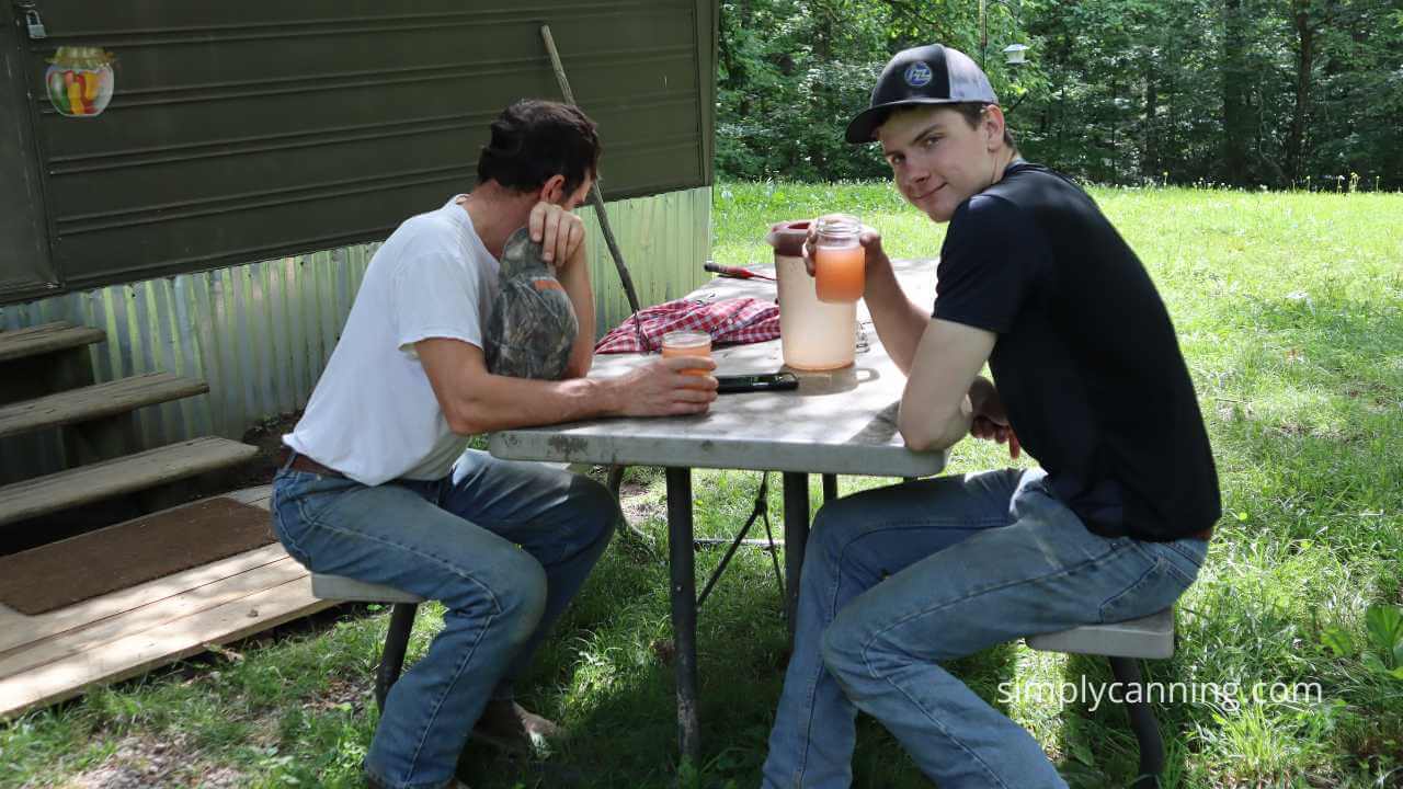 My husband and son sitting at a picnic table enjoying strawberry lemonade,  they liked it! 
