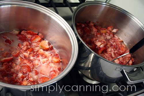 2 pots of strawberries cooking. 