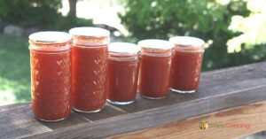 Pint and half pint jars of tomato juice.