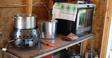 A volcano stove and dehydrator sitting outdoors.