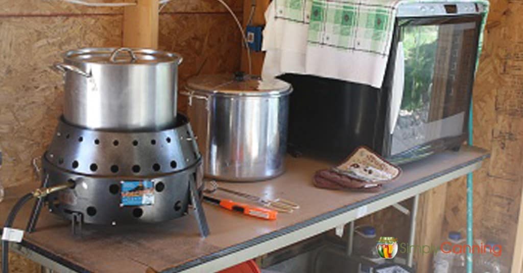 A pot sitting on the Volcano Stove on a table under the carport.