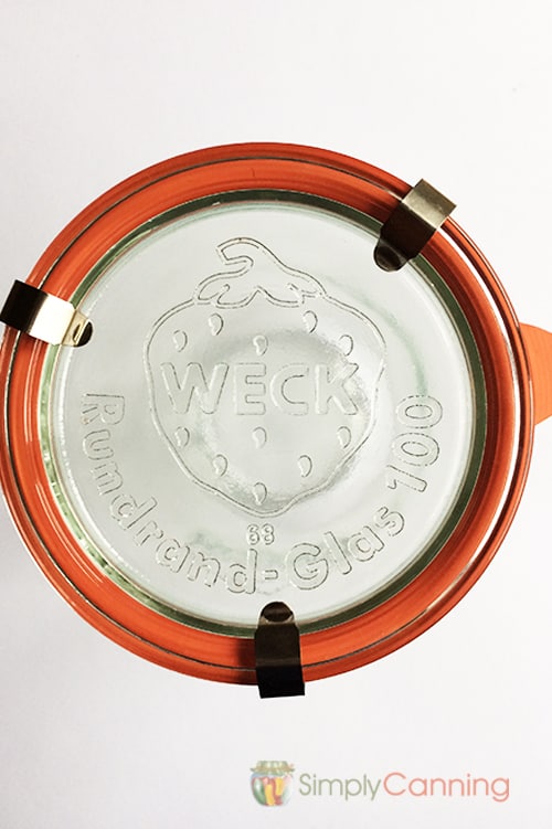 Weck jar lid with the strawberry logo on top.